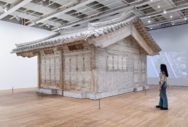 a life-size installation of a traditional Korean home made of white fabric in a gallery space