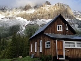 a brown building against mountain backdrop