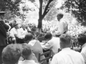 Two people having a discussion among a crowd of people watching.