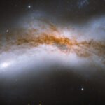 A bright cloud of cosmic material stretches across a dark void