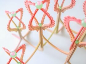 detail of a pink and yellow curved sculpture with scalloped edges