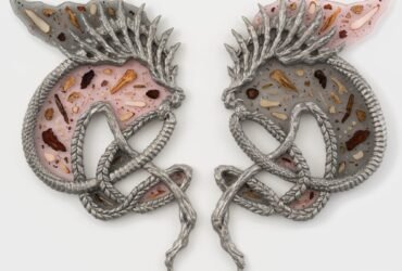 two creature like sculptures facing each other with translucent bodies of dried herbs