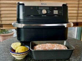 Ninja air fryer with a loaf cake in a tine in front of it
