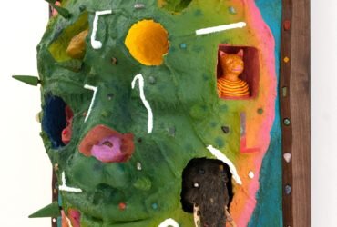 a side view of a wooly mammoth, pink animal, bell, and other objects embedded into a sculptural painting shaped like a face