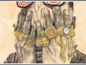 a man holds his hands over his eyes and each finger has a big gold ring with gems
