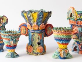 a series of five elaborate, multi-colored ceramic vases made with clay piped like frosting