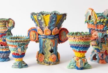 a series of five elaborate, multi-colored ceramic vases made with clay piped like frosting
