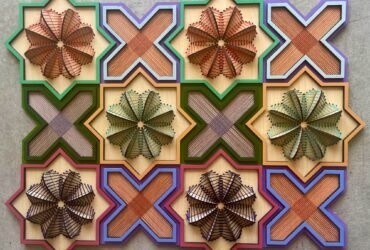 a geometric, sculptural floral embroidery on wood